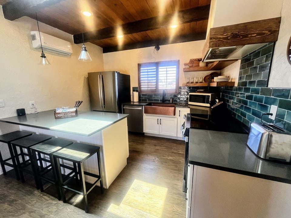 Cook meals together in the remodeled, fully equipped and stocked kitchen with island seating for four