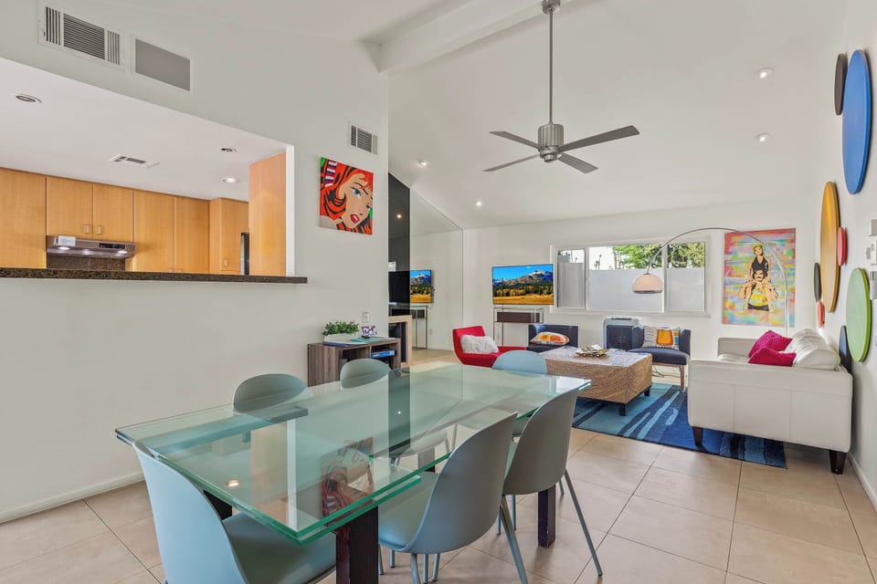 Glass dining table seats 6, fully stocked with dinnerware for memorable meals & entertaining.