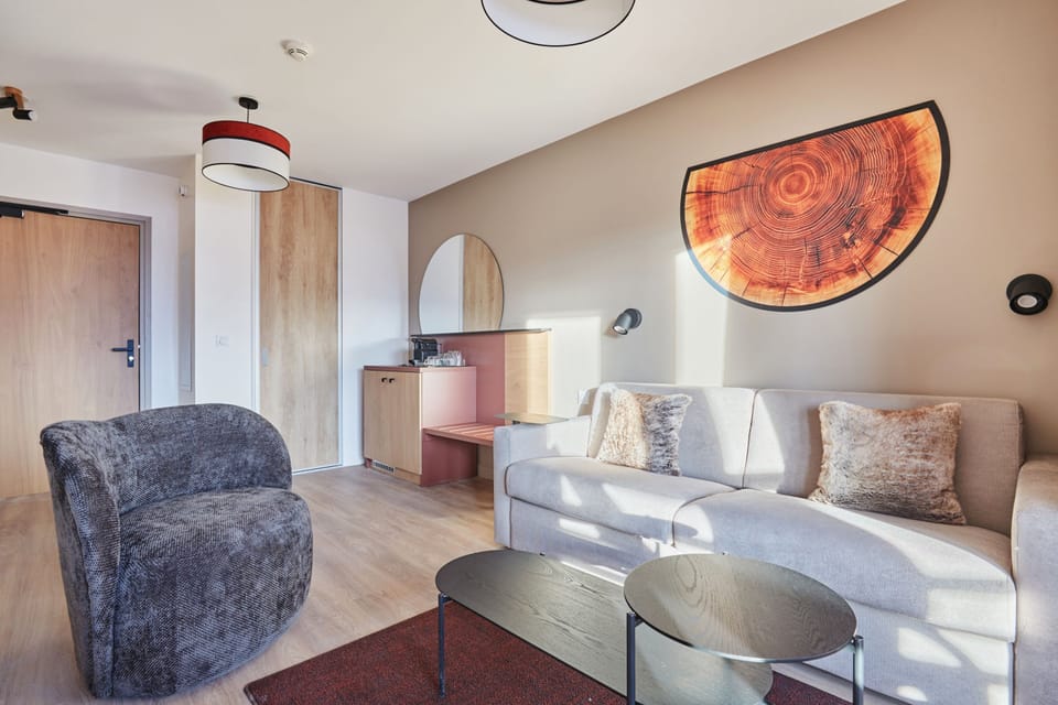 Bright seating area with natural light and a coffee machine on the cabinet — a practical base for mountain days.
