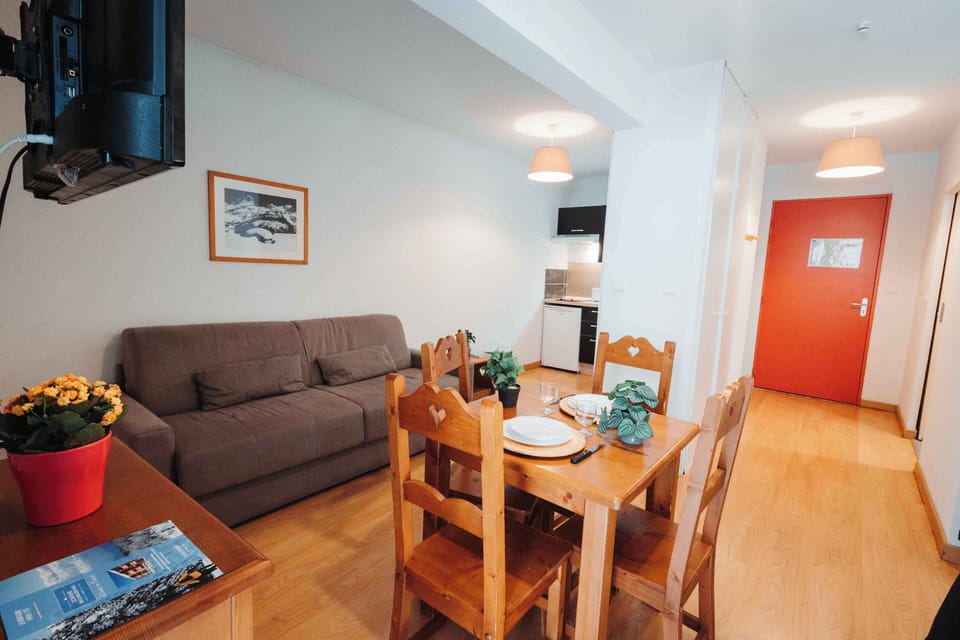 Unwind in the cozy lounge area featuring flexible sleeping space and natural light.