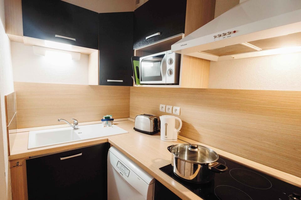 Compact and efficient kitchenette with electric hob, microwave, and all your cooking essentials.