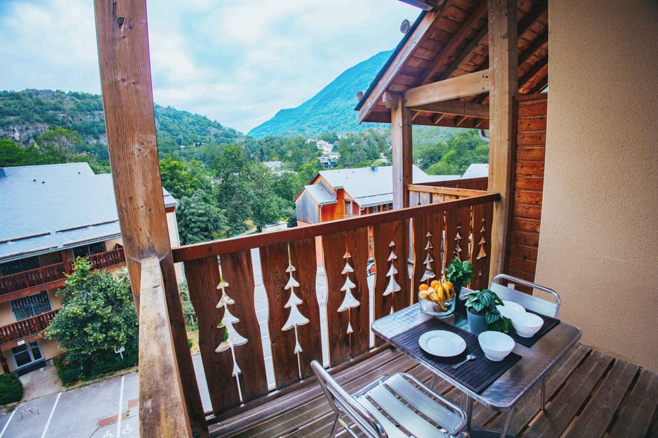 Enjoy morning coffee on your balcony with serene mountain views—perfect for a group of four.