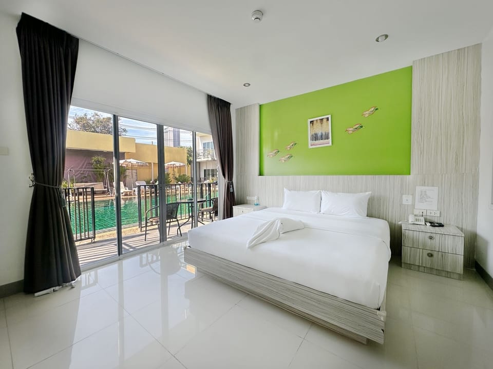 Deluxe Room, Pool Access | Minibar, in-room safe, desk, free WiFi