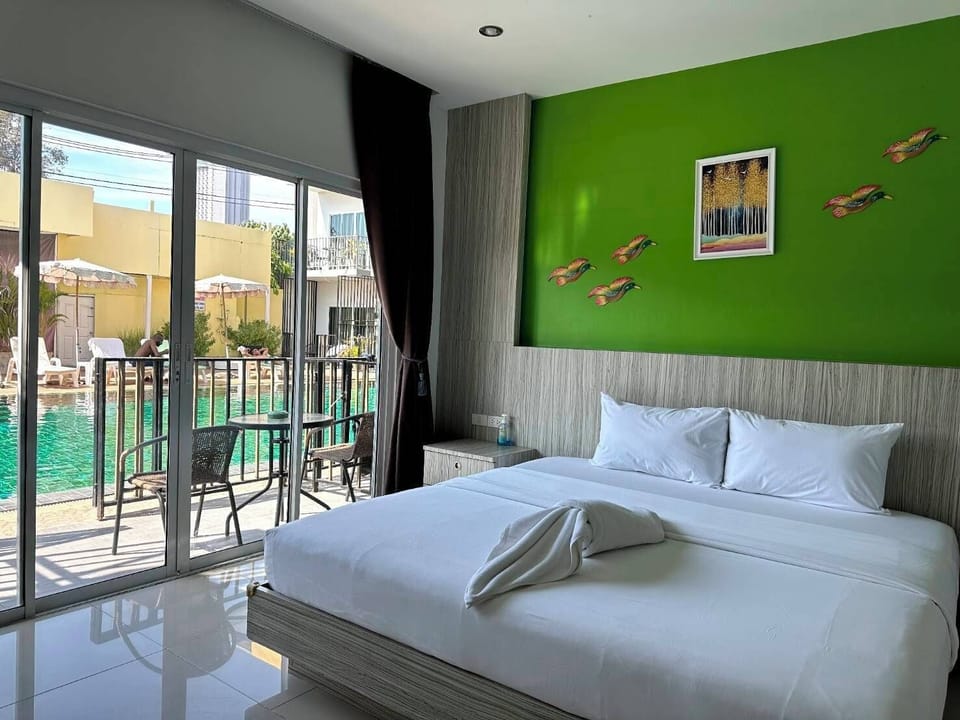 Deluxe Room, Pool Access | Minibar, in-room safe, desk, free WiFi