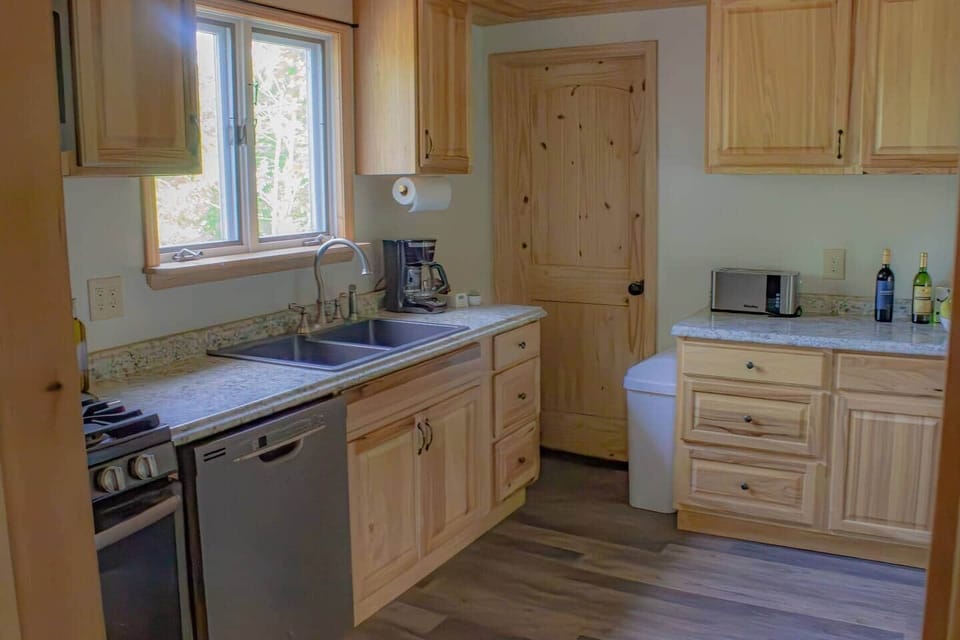 Dishwasher and a gas stove.  There are pots, pans, and utensils to prepare any meal!
