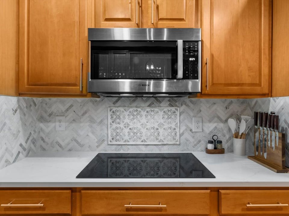 Glass cooktop and microwave in kitchen 