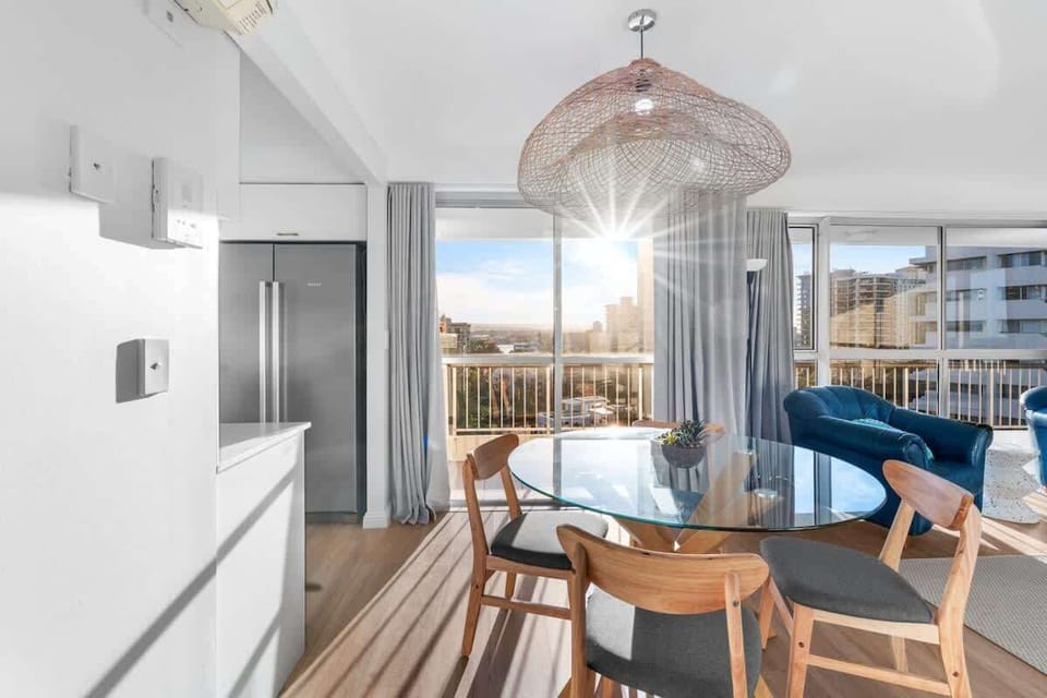 Dining area set beside the kitchen, bathed in golden sunset light from the west-facing windows.