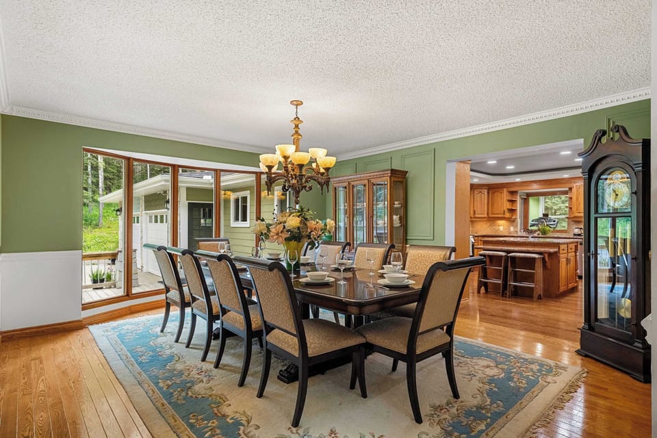 Formal dining area with forest views and natural light