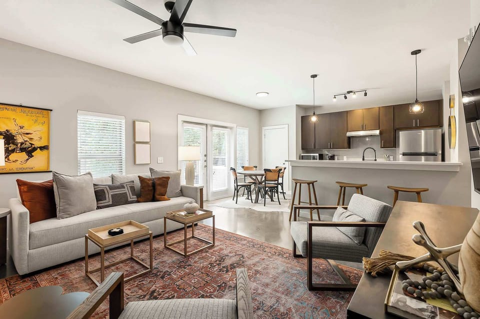 Step into the heart of the home. A warm, inviting, open layout living room bathed in natural light. 