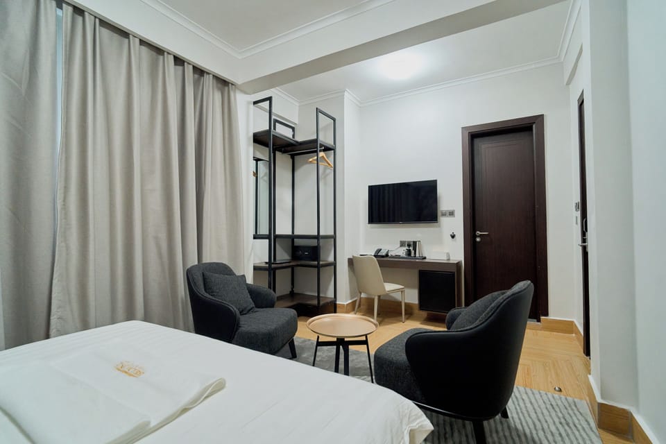 Deluxe Suite, Balcony, City View | In-room safe, soundproofing, iron/ironing board, free WiFi