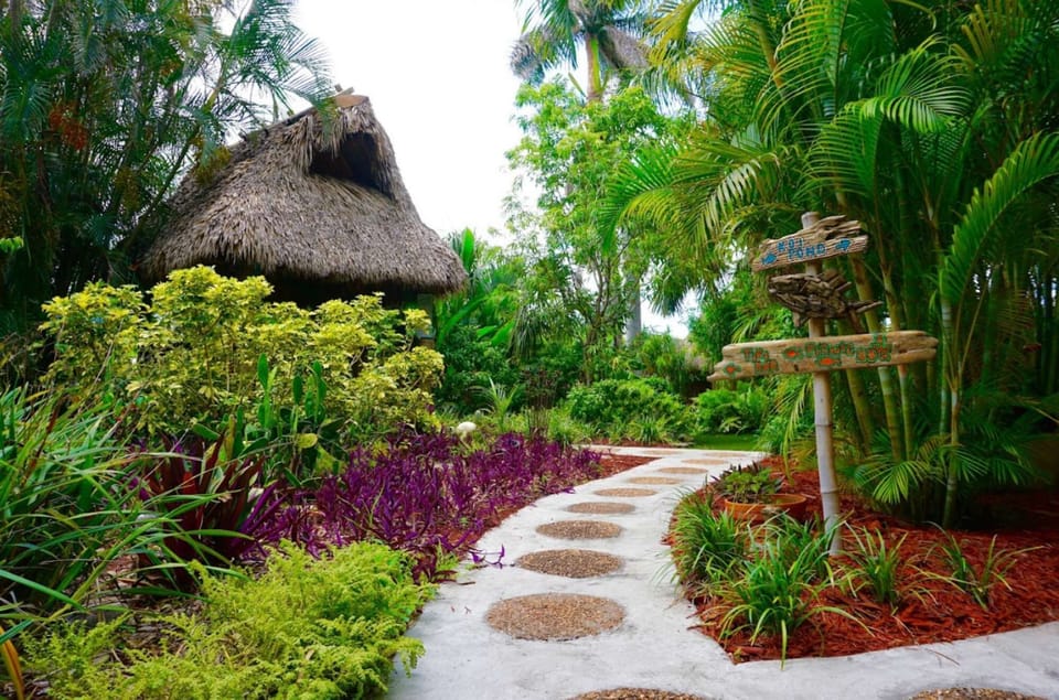 Garden path with plants, flowers, and stone walkway leading ahead