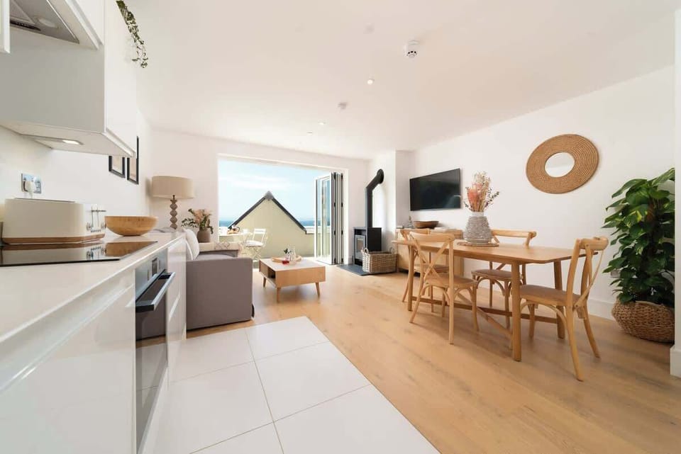 Experience the expansive elegance of our open-plan living room, which is built for comfort and easy relaxation in the centre of your stay.