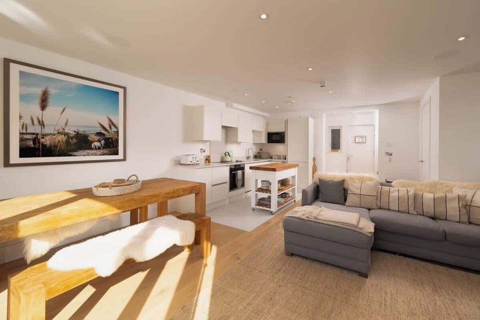 Experience the expansive elegance of our open-plan living room, which is built for comfort and easy relaxation in the centre of your stay.