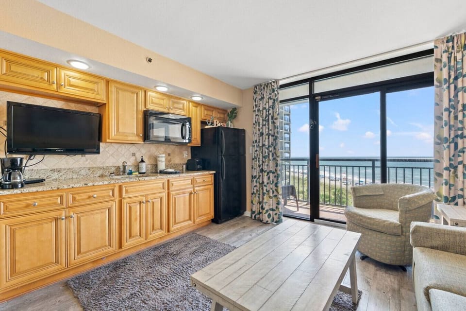 Oceanfront kitchen with smart tv, cookware, dinnerware, silverware, and all major appliances.