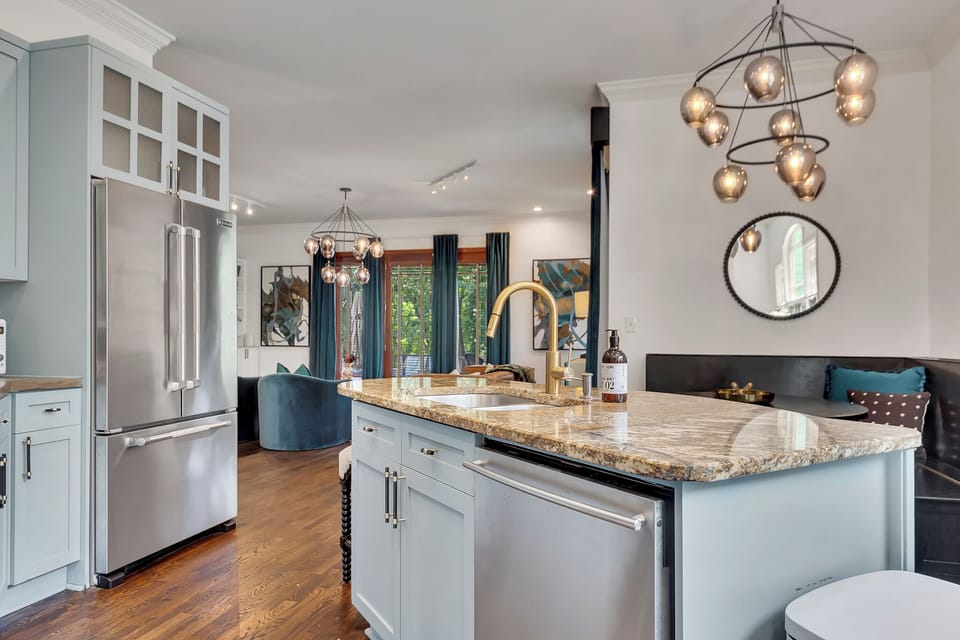 Breakfast nook goals! Seamless design flows from the built-in seating right into the modern, bright kitchen. 