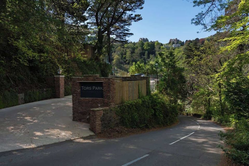 The entrance to Tors Park on Countisbury Hill offers a scenic and convenient arrival point, with a well-lit path leading from the private parking area to the apartments.
