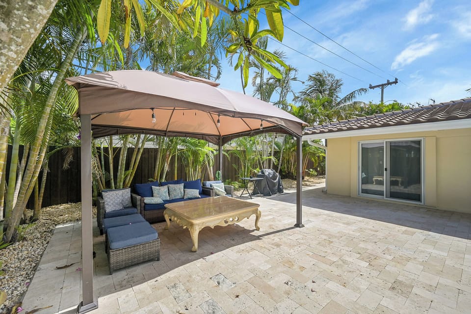 Canopy with lights and fan and large table for dining al fresco