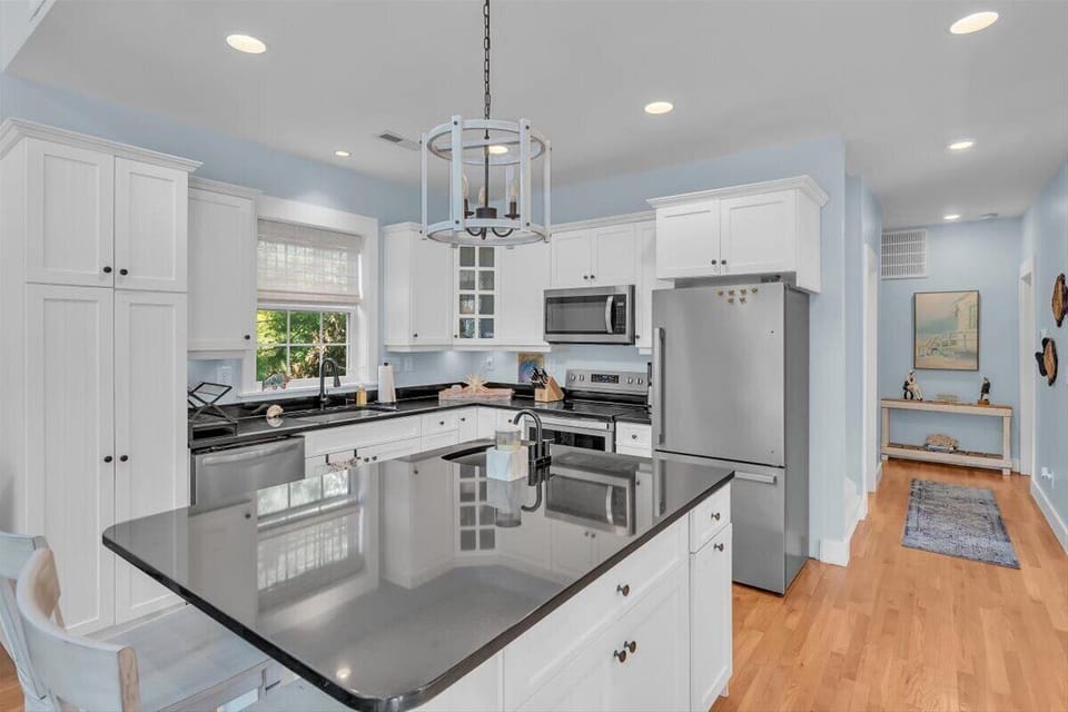 Cook your favorite meals in this bright, fully-equipped kitchen with granite countertops, stainless steel appliances, and plenty of cabinet space for all your needs.