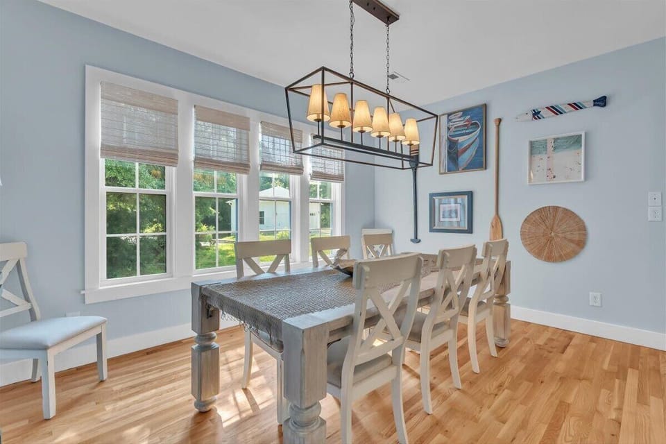 Gather around this charming dining table where your meals become memories, bathed in natural light from oversized windows.