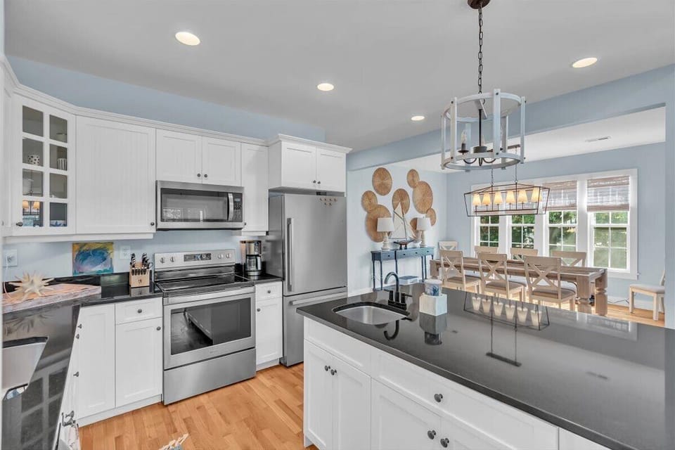 Step into your bright kitchen where gleaming granite counters and modern appliances make cooking a joy, with open dining space perfect for gatherings.