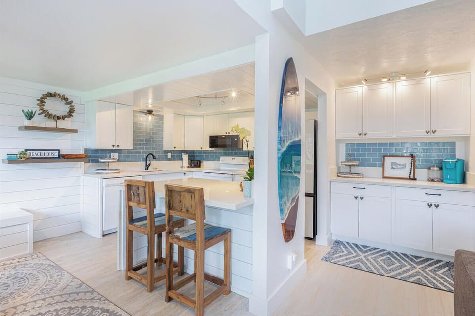 Fully stocked kitchen with quartz island and stainless appliances for effortless cooking.