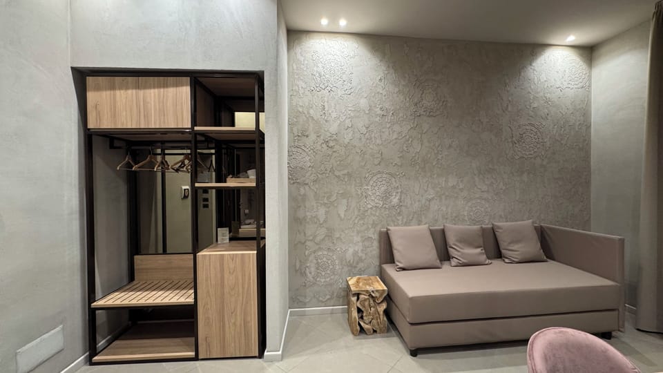 Deluxe Triple Room, Balcony, City View | Living area | TV