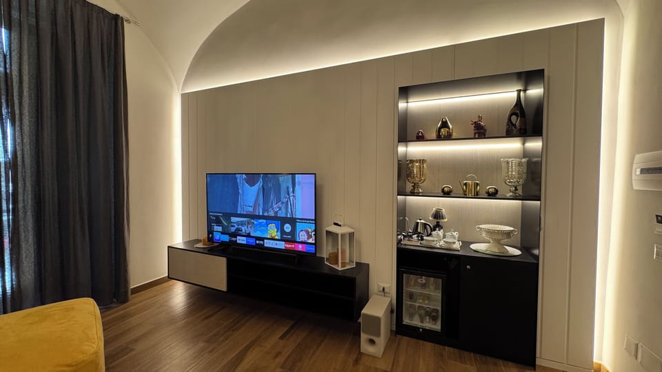 Deluxe Suite, Balcony, City View | Living area | TV