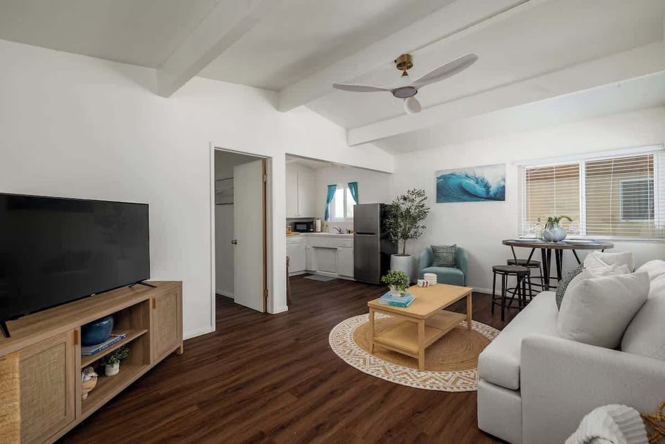 Living room (AC, TV, ceiling fan, sofa bed, dining table)