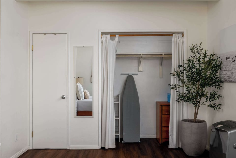 Bedroom with clothing storage and ironing kit