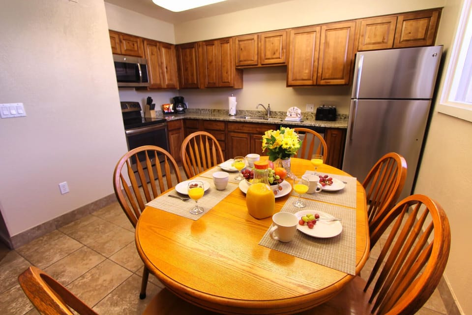 Dining area with seating for the group — full kitchen with oven, dishwasher, and cookware steps away