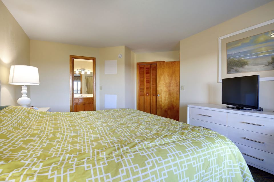 The inviting bedroom features soft bedding and natural light, creating a serene space for couples or small families to unwind.