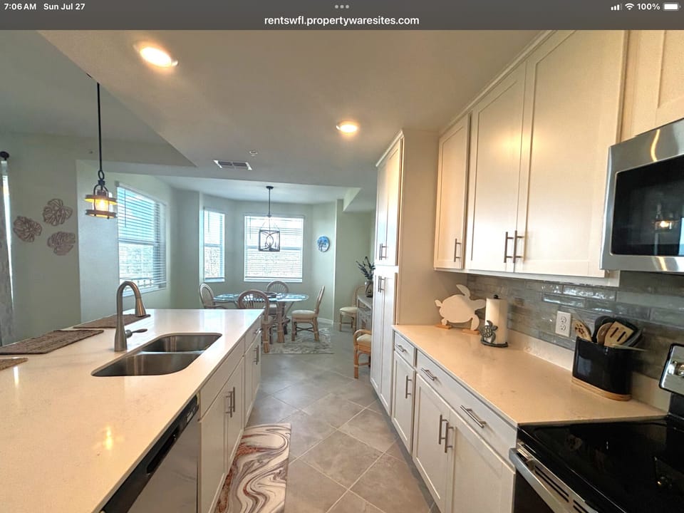 Kitchen with electric range, microwave and large refrigerator with ice maker 