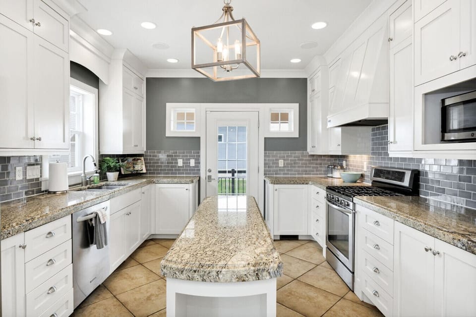 Fully stocked kitchen equipped with a Keurig (pod and drip), slow cooker, waffle maker, griddle, rice cooker, blender, and new microwave, stove, and dishwasher