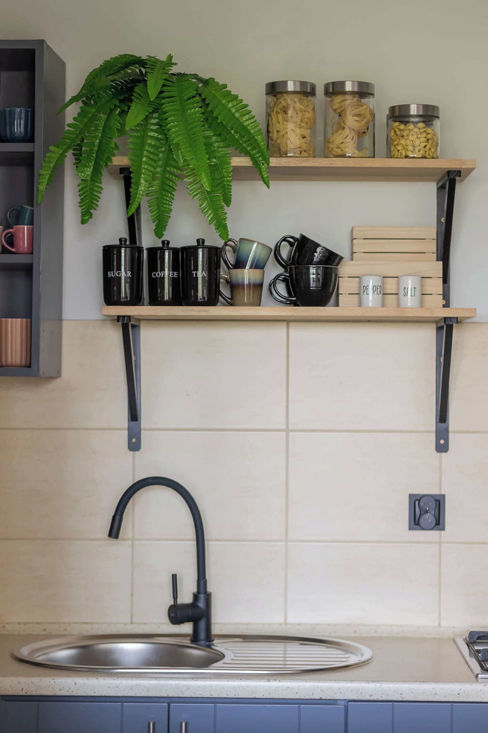 Shelves with plants and kitchen essentials to bring freshness indoors.