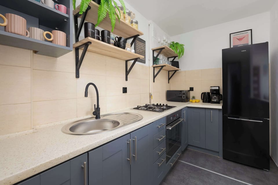 Clean kitchen space with essential appliances and sleek cabinetry.