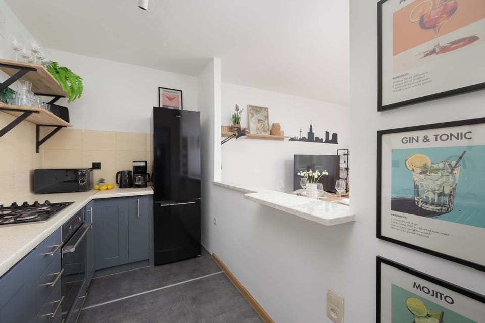 Compact kitchen with appliances, utensils, and decor for a functional cooking space.