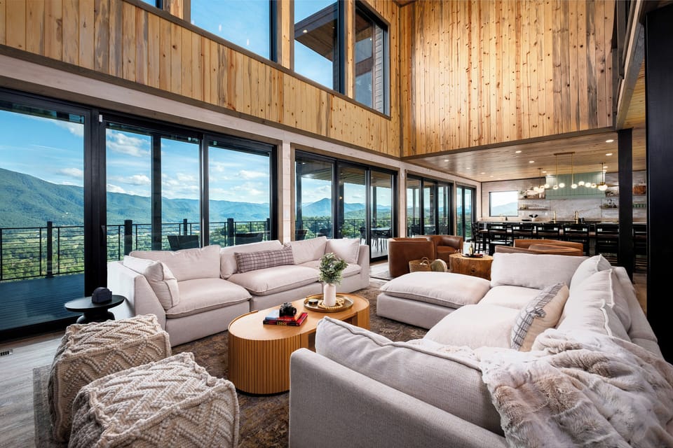 Living room with expansive mountain views and multiple seating areas
