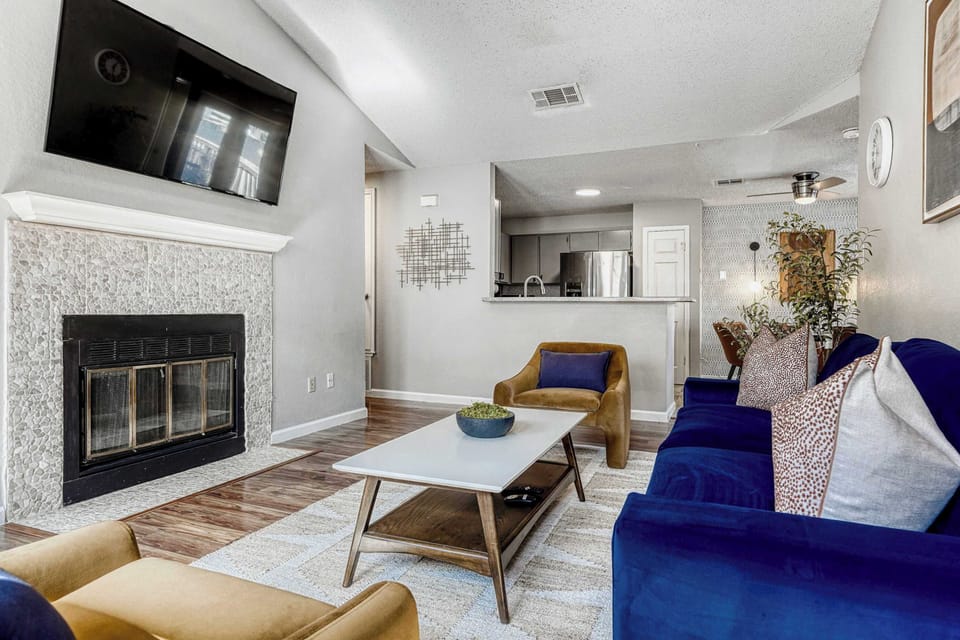 Stylish, airy living space with fireplace centerpiece and inviting layout for connection and comfort