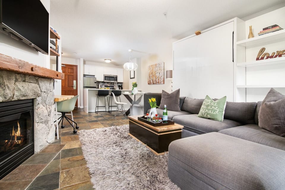 Sectional sofa, stone fireplace, smart TV.