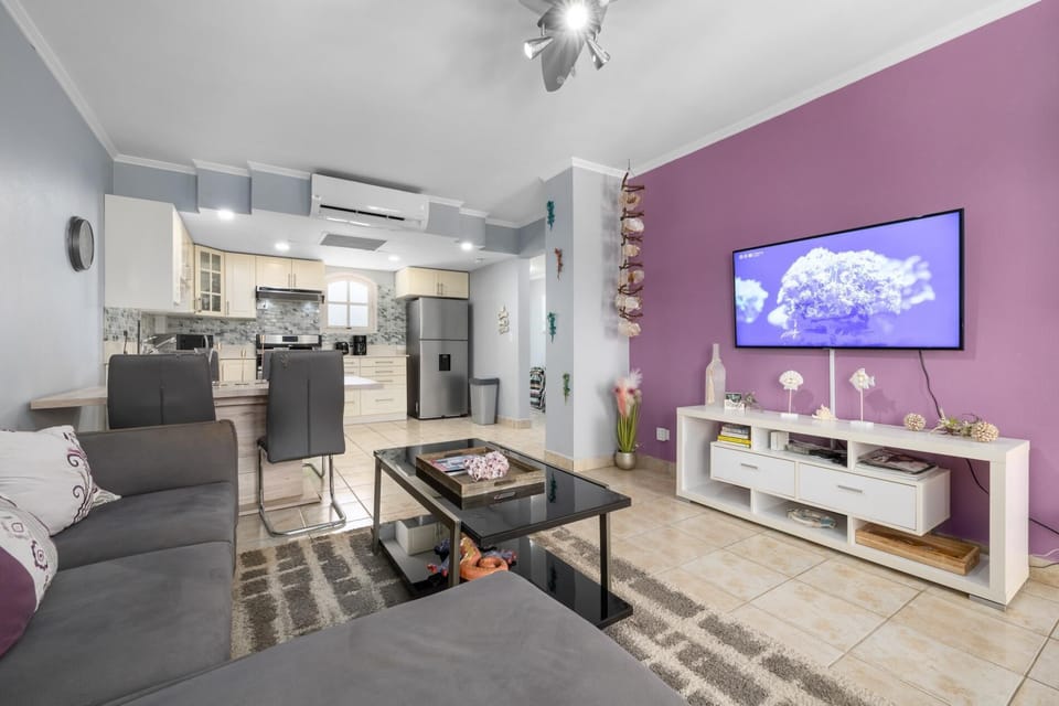 Sink into the cozy L-shaped sofa, stream Netflix on the 50" smart TV, or enjoy time with loved ones. This open-concept space blends living, dining, and kitchen areas for easy, relaxed gatherings.  Sofabed  and Balcony access
