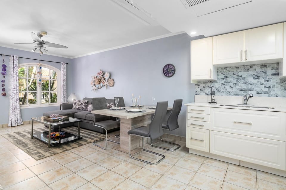 Welcome to a bright, open-concept space where the living room flows into the dining area and kitchen. This airy layout blends comfort and function—perfect for unwinding after exploring or enjoying a cozy night in.