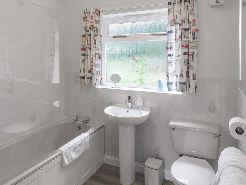 The downstairs master bathroom with bath & shower | Foxes Retreat, Thornton Watlass, near Masham