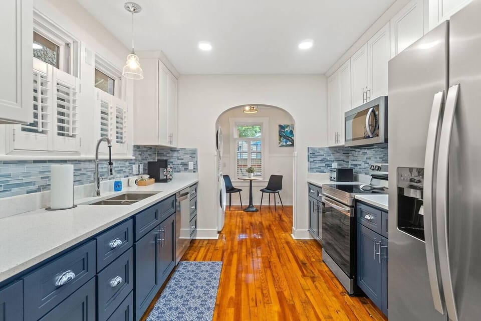 Fully-equipped gourmet kitchen perfect for family meal prep with modern appliances, sleek finishes, and abundant natural light in downtown Pensacola.