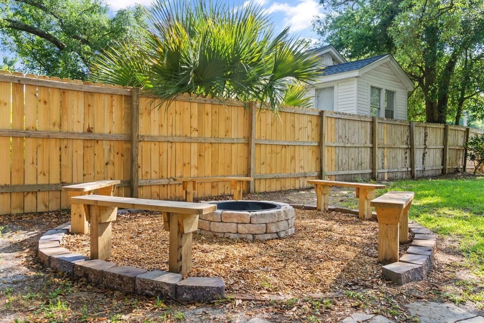 Fire pit seating area perfect for adult evening gatherings and family s'mores, minutes to downtown Pensacola nightlife.