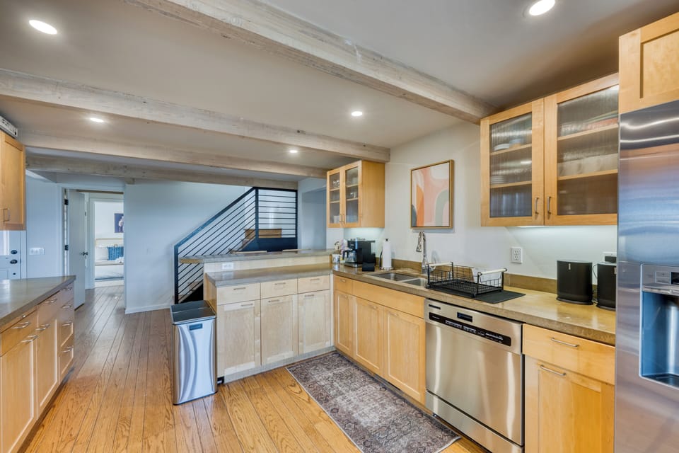 Modern kitchen with ample counter space, stainless steel appliances.