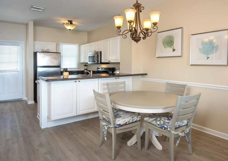 Gather for relaxed meals under warm chandelier lighting.