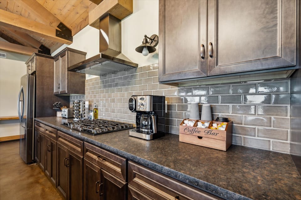 Fully equipped cooking space with double ovens, gas range, and custom cabinetry—perfect for group meals and lodge-style feasts.