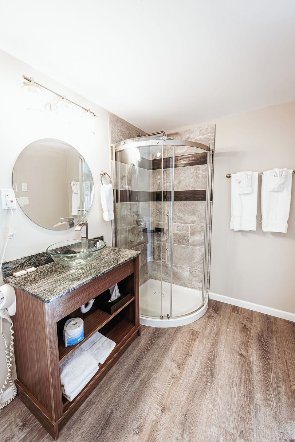 Refresh in a sleek bath with glass shower and vanity.