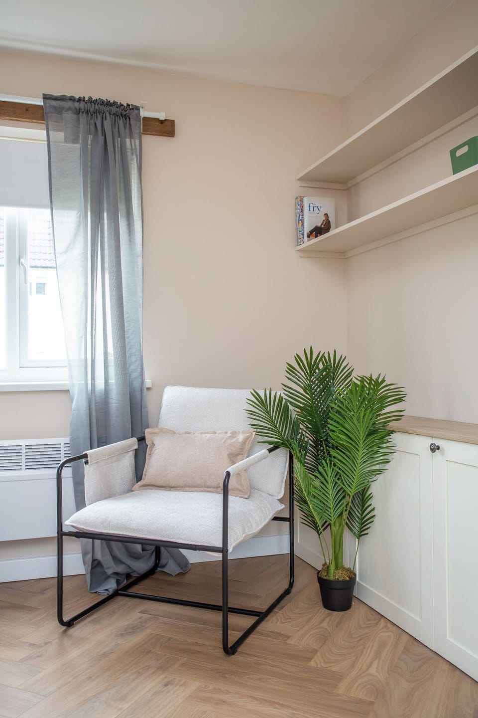 A peaceful reading nook with a soft armchair and natural light streaming through the window
