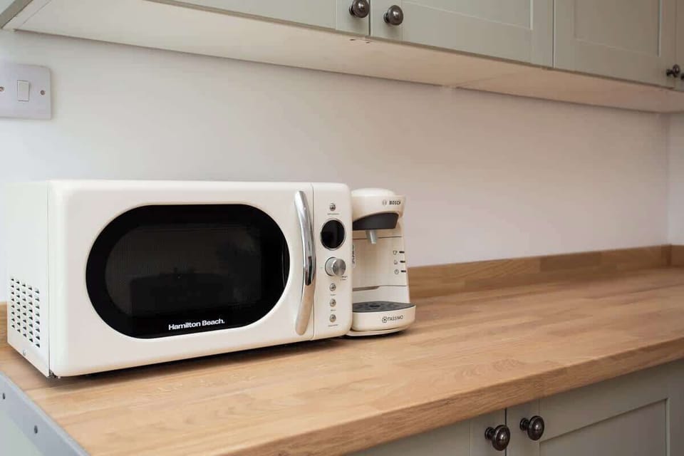 Fully equipped kitchen featuring modern appliances, including a microwave and coffee maker for your convenience